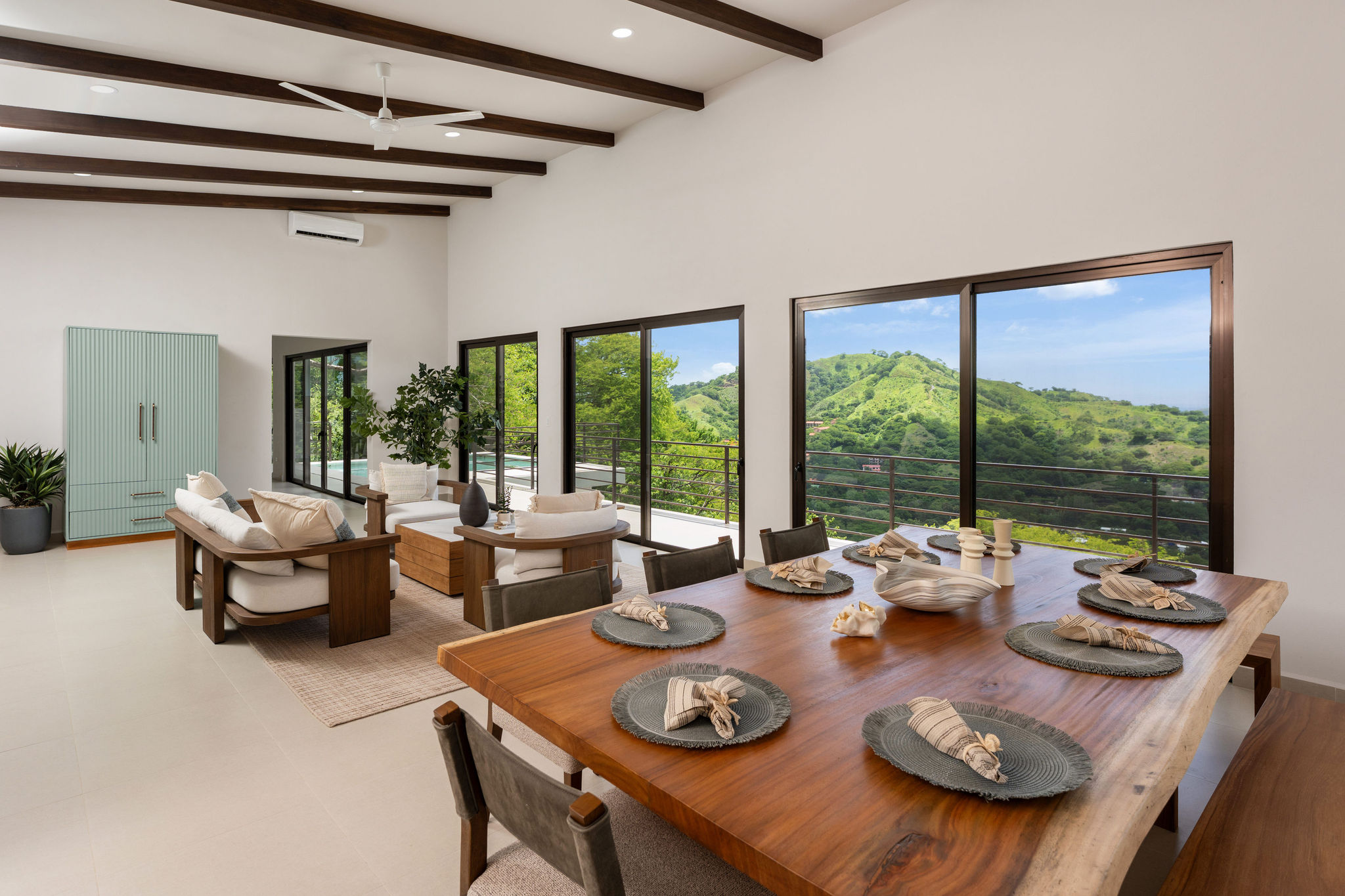 Open living and dining area with ocean views through sliding glass doors