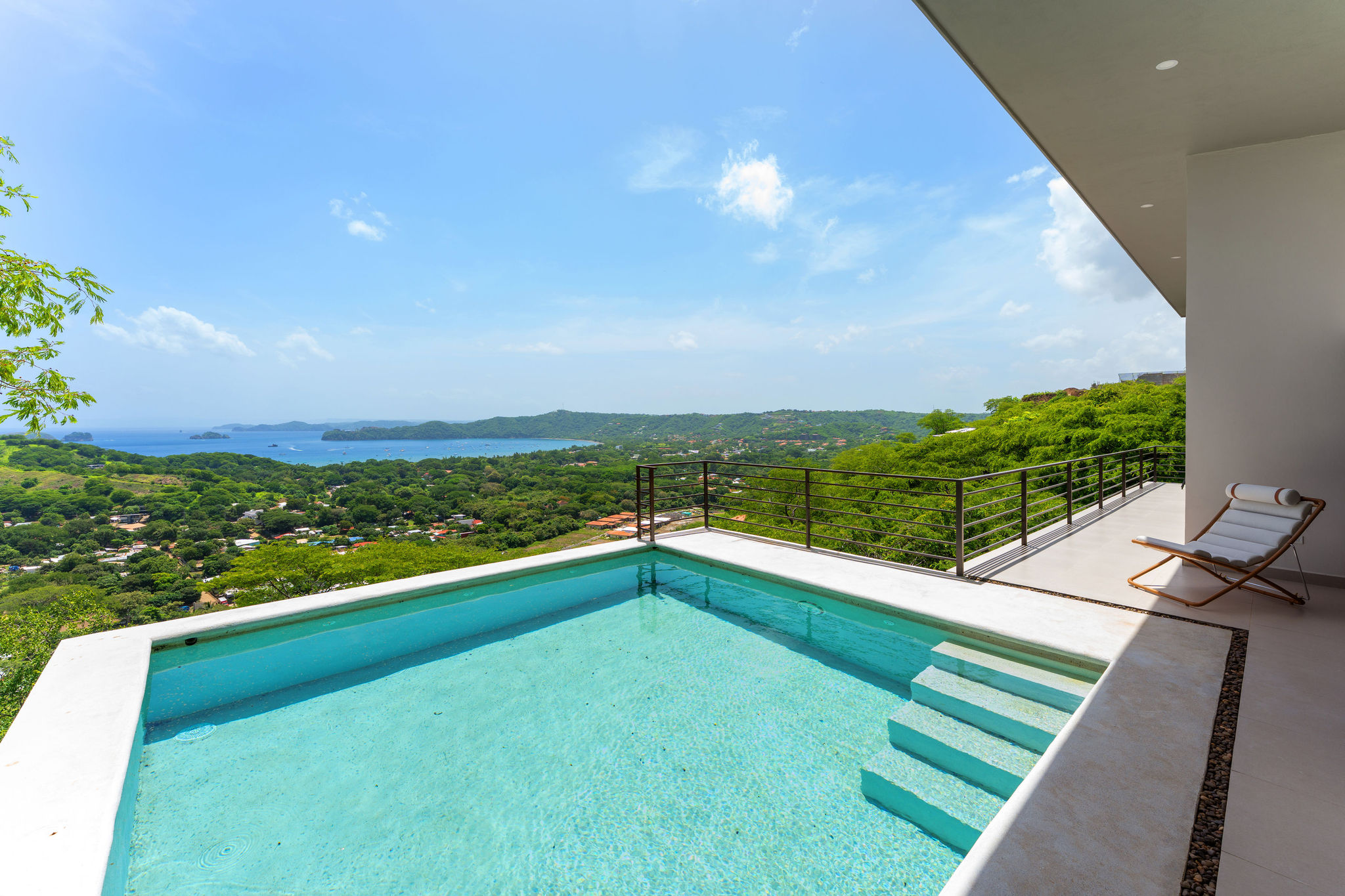 Casa Cielo’s private pool overlooking the Pacific coast and green hills near Playas del Coco