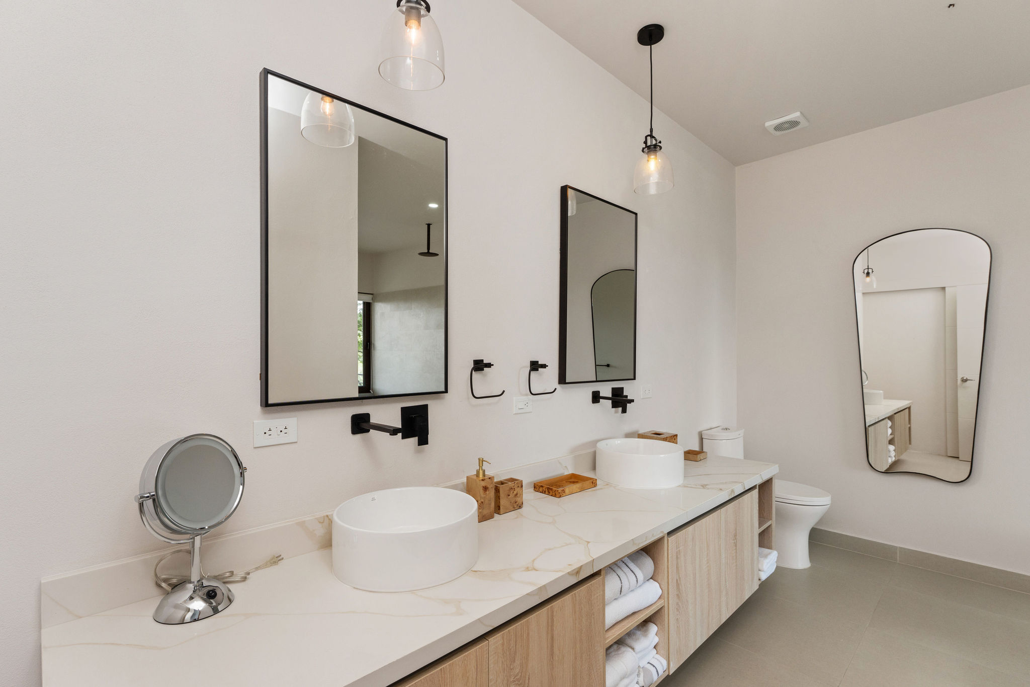 Bathroom vanity with double sinks and folded towels