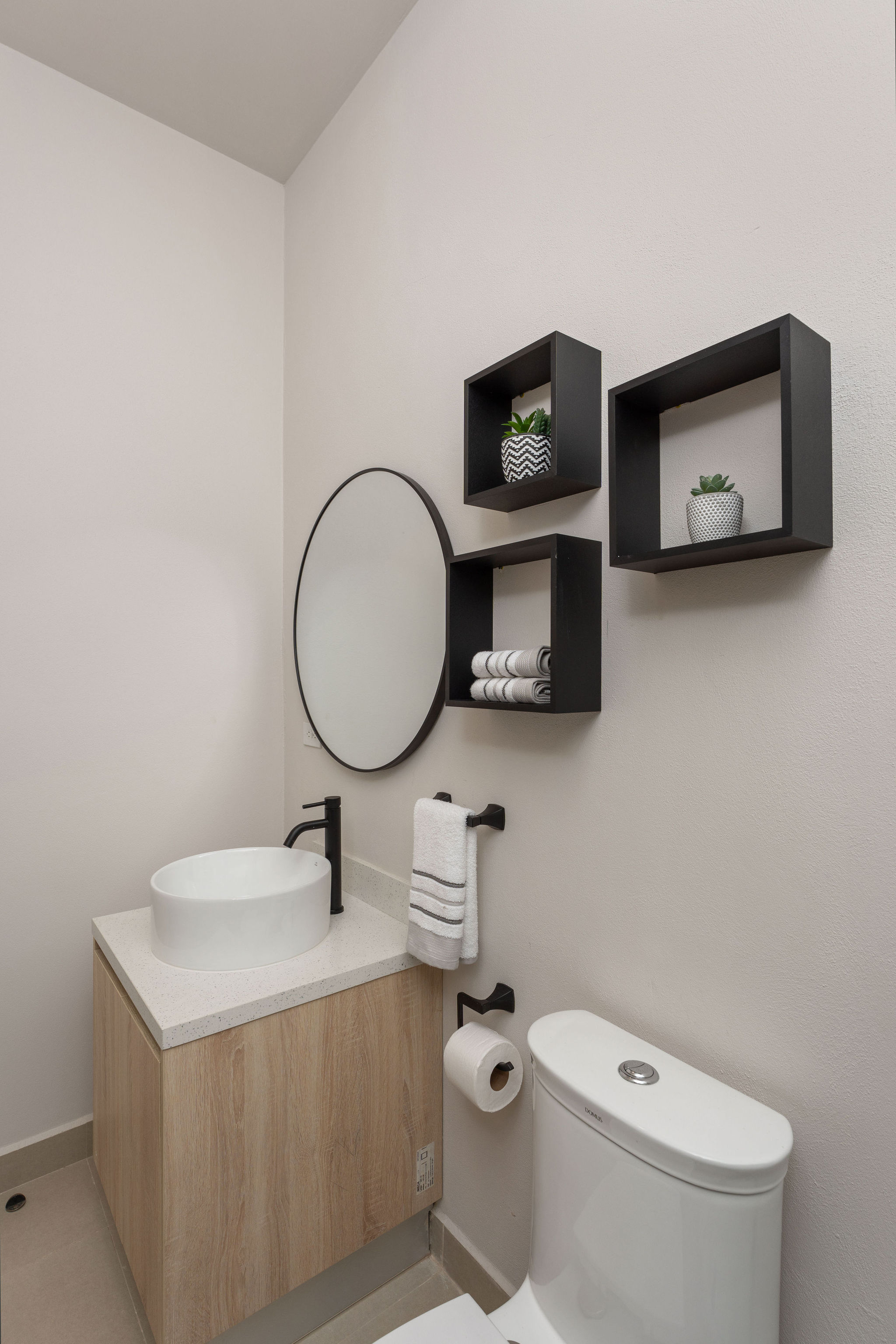Guest bathroom vanity with round mirror
