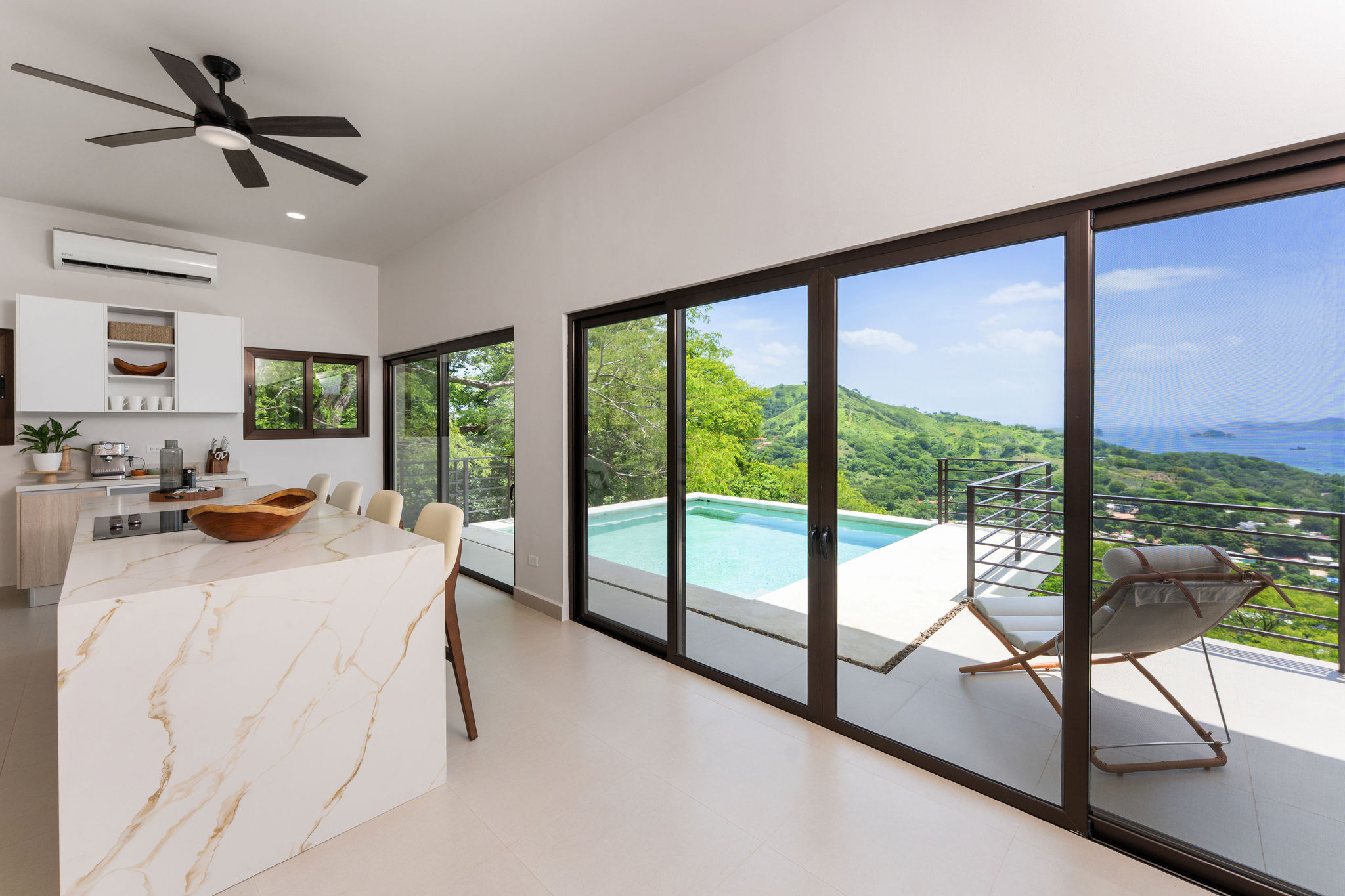 Open kitchen with sliding glass doors to the pool deck
